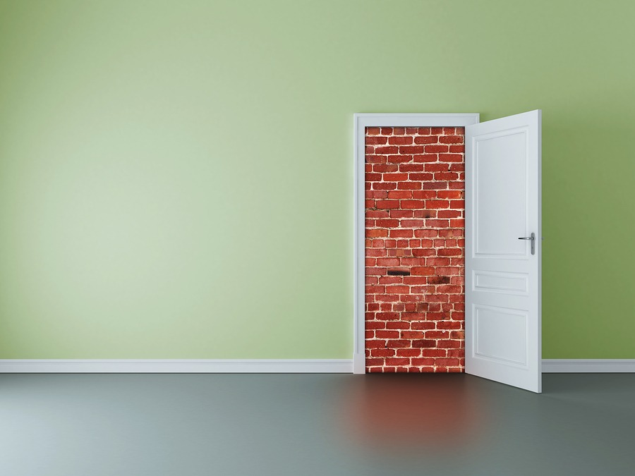 Door Open To Show a Brick Wall